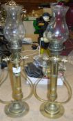 A pair of brass gimble candle lights with glass shades. Size approx.