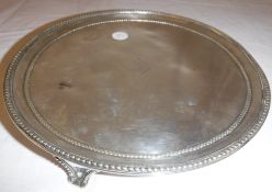 A late George III silver card tray of plain form with beaded edge,