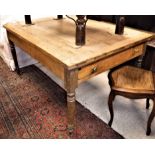 A pine farmhouse kitchen table the cleated ends over an end drawer,