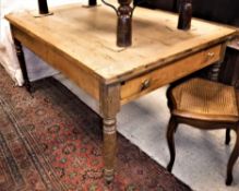 A pine farmhouse kitchen table the cleated ends over an end drawer,