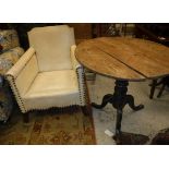 A Victorian painted pine pedestal tea table and a simulated leather and studded arm chair Size