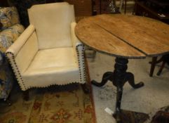 A Victorian painted pine pedestal tea table and a simulated leather and studded arm chair Size