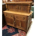 A mid 20th Century carved oak court cupboard,