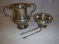 A collection of silver ware to include a twin-handled trophy cup, a small pedestal bowl,