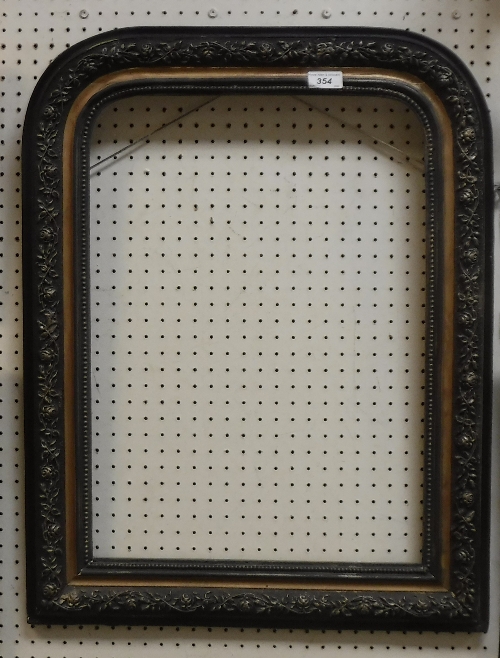 A 19th Century French ebonised arched mirror frame with floral decoration (no glass) Size approx.