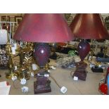 A pair of Regency style patinated red lacquered table lamps on plinth bases