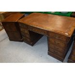 A modern burr walnut kneehole desk with tooled and gilded writing surface,