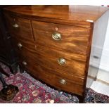 An early 19th Century mahogany bow fronted chest of two long graduated drawers on splayed bracket