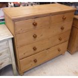 A pine chest of two short over three long drawers on turned feet Size approx 106cm long x 99cm