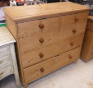 A pine chest of two short over three long drawers on turned feet Size approx 106cm long x 99cm