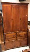 A Victorian mahogany housekeeper's cupboard three arch panel doors enclosing shelving over two four