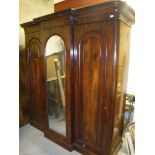 A Victorian mahogany breakfront triple wardrobe with mirrored centre section Size approx.