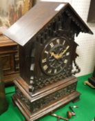 A late 19th Century carved oak cased mantel cuckoo clock,