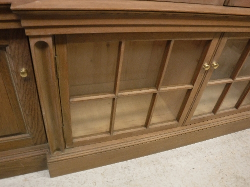 A large oak framed breakfront bookcase cabinet in the Arts and Crafts taste with six glazed and - Image 23 of 23