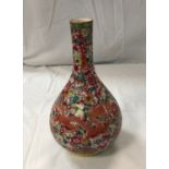 A circa 1900 Chinese porcelain Qing Dynasty bottle vase decorated with painted red dragon motif