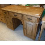 A pine pedestal sideboard with three frieze drawers over two cupboard doors Size approx.