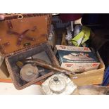 A coracle wicker picnic set containing kettle and burner, sandwich tin and further tin,