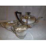 A George V silver three piece tea set with semi-reeded decoration (teapot by John and William F.