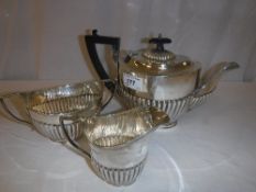 A George V silver three piece tea set with semi-reeded decoration (teapot by John and William F.