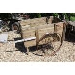 A vintage wooden cart with iron wheels Size approx.