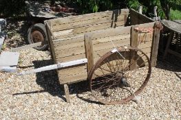 A vintage wooden cart with iron wheels Size approx.