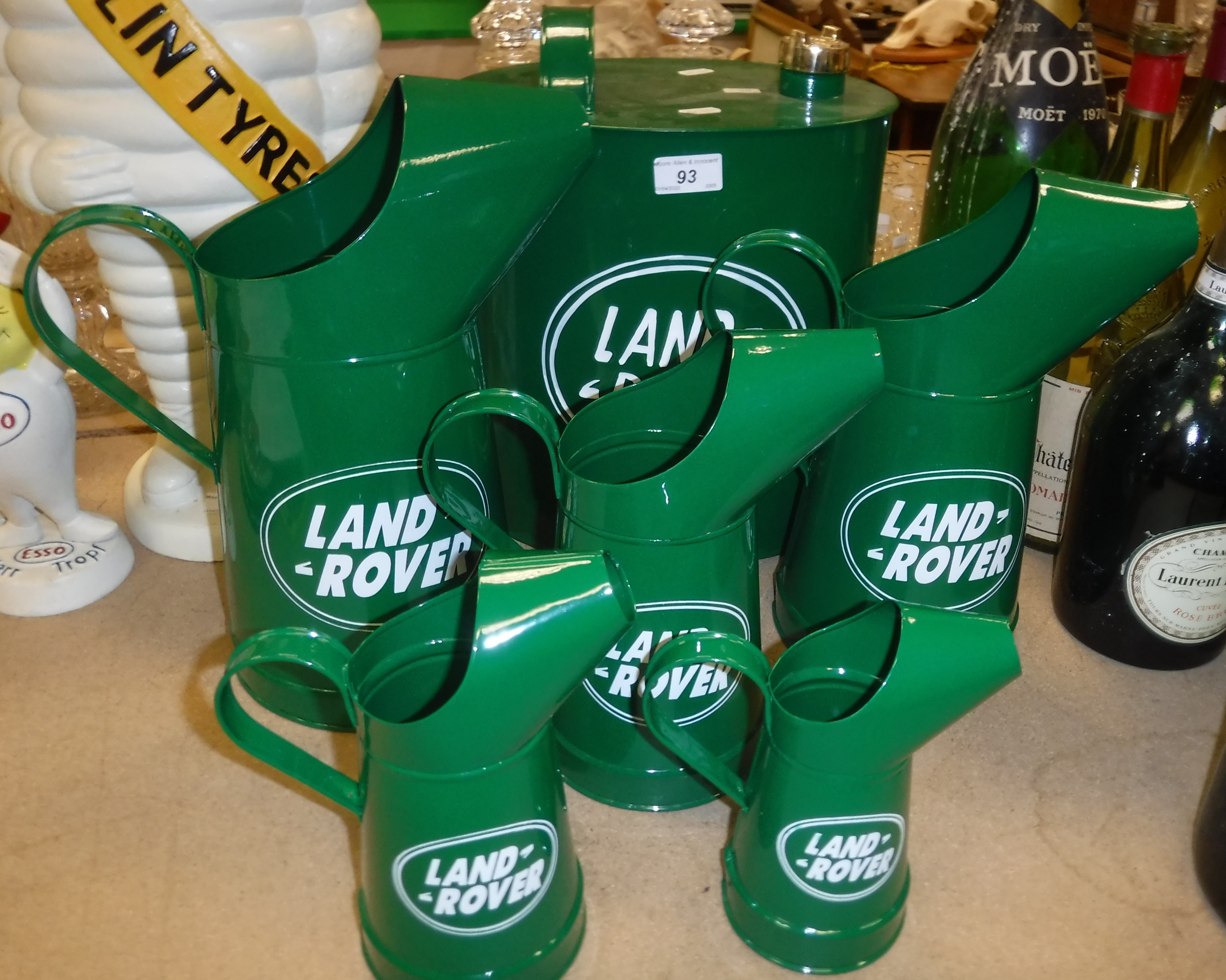 A modern "Landrover" petrol can and a graduated set of five "Landrover" oil jugs