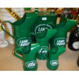 A modern "Landrover" petrol can and a graduated set of five "Landrover" oil jugs