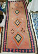 A 20th Century Kelim rug in blue, red, brown and orange,