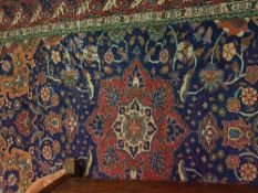 A Caucasian rug with centre medallion on a blue ground with all over scrolling foliate decoration