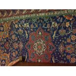 A Caucasian rug with centre medallion on a blue ground with all over scrolling foliate decoration