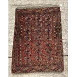 A Bokhara Tekke rug with all over elephant foot medallions on a red ground,