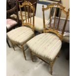 A pair of late 19th Century gilt decorated occasional chairs with ribbon decoration to top,