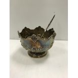 An embossed silver punch bowl, together with a Georgian silver and whale bone punch ladle,