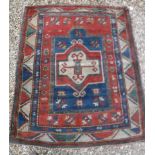 A Kazak prayer rug with centre medallion on an architectural style blue ground, within a red field,