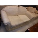 A cream floral upholstered two seat sofa and another similar two seat sofabed,