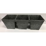 A set of three interconnected galvanised planters