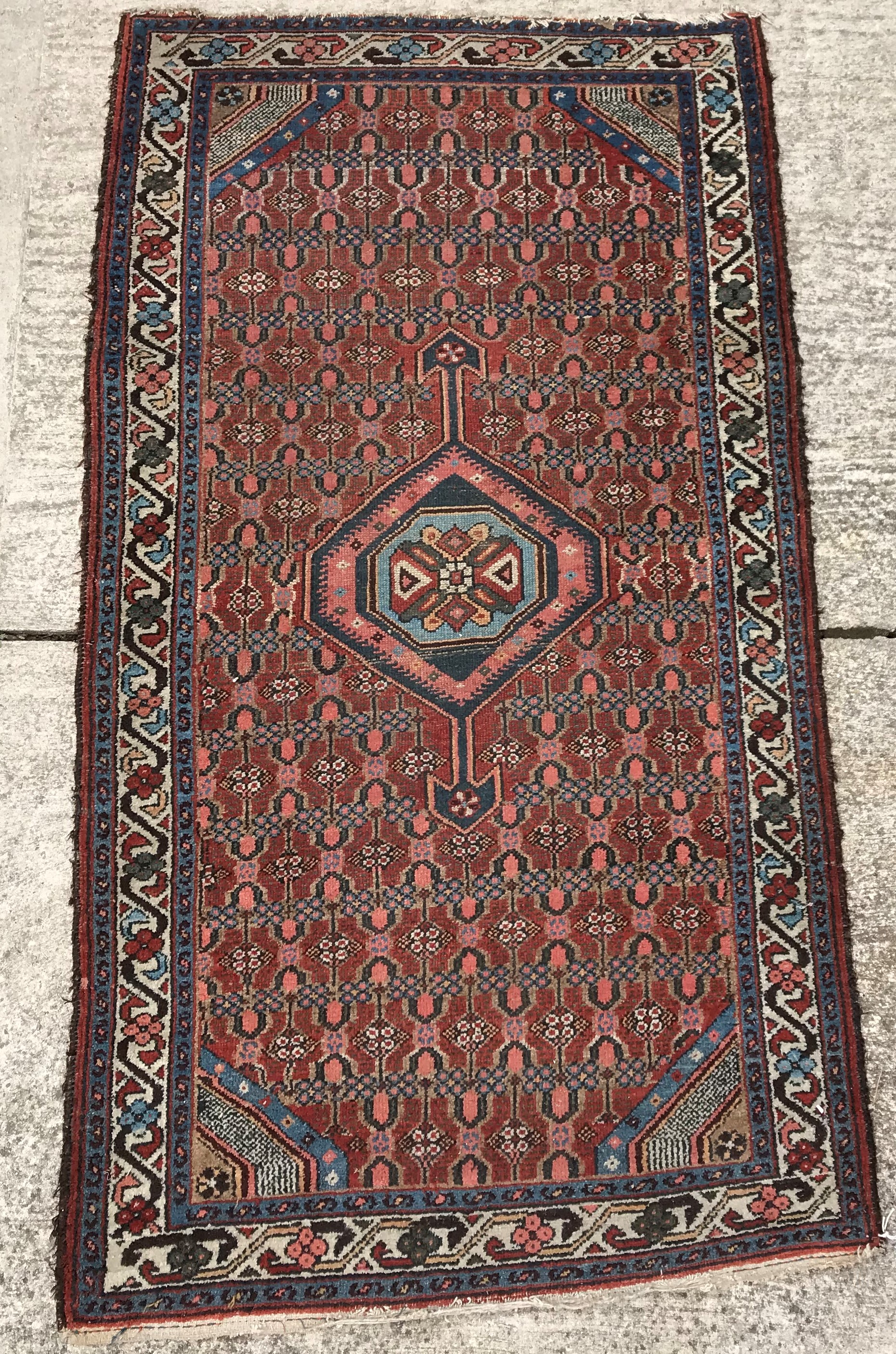A Caucasian rug with central lozenge shape medallion on a lozenge medallion decorated ground,