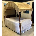 A 19th Century American cherrywood four poster bedstead with domed cover on turned and rope twist