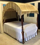 A 19th Century American cherrywood four poster bedstead with domed cover on turned and rope twist
