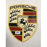 A painted cast metal "Porsche" sign