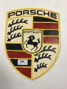 A painted cast metal "Porsche" sign