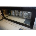 A large modern leather framed wall mirror,