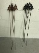 A set of iron plant stakes and a set of black painted iron plant stakes