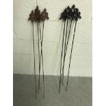A set of iron plant stakes and a set of black painted iron plant stakes