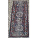 A circa 1900 Persian runner with repeating medallion decoration on a blue ground,