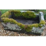 A rectangular natural stone trough with shallow D end,