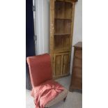 A Victorian upholstered nursing chair on turned legs to brass caps and castors,