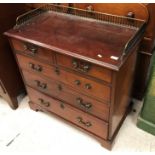 A late George III mahogany dressing chest, the three quarter galleried top over two short drawers,