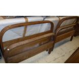A pair of Heal's oak bentwood single bedsteads with springs