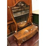 A late Regency mahogany shield shaped toilet mirror with three drawers to base,